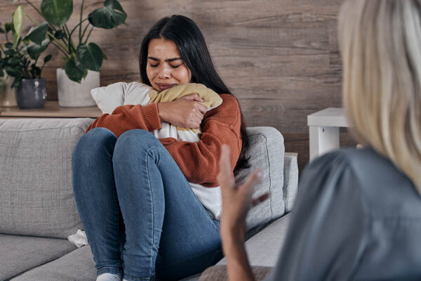 Counseling, psychology woman and patient crying in therapy for mental health problem, depression or.